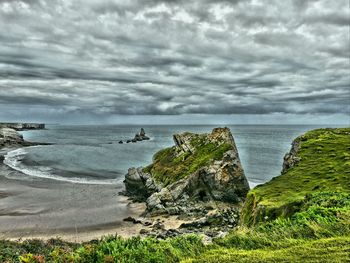 Scenic view of sea against cloudy sky