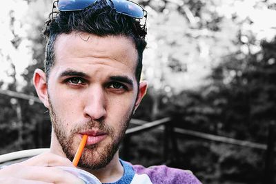 Portrait of young man smoking