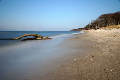 Scenic view of beach against clear sky