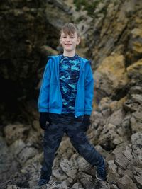 Portrait of boy standing on rocks