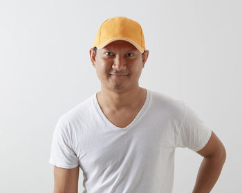 Portrait of smiling young man against white background