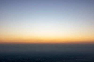 Aerial view of cityscape against clear sky during sunset
