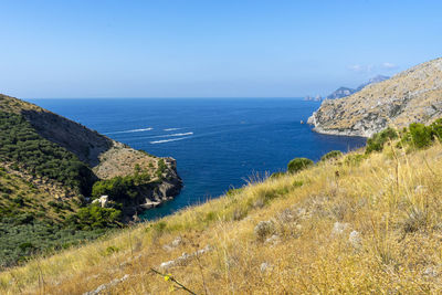 Scenic view of sea against clear blue sky