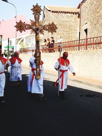 Men on cross against sky