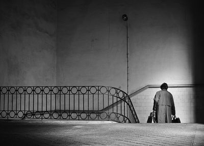 Rear view of woman in stairs