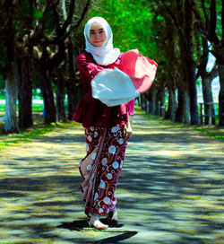 Full length of woman standing in park