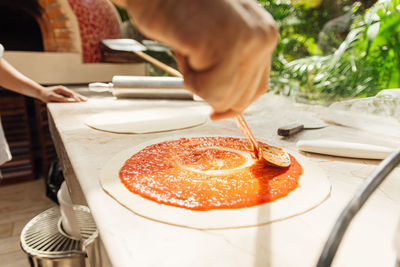 Cropped hand of person preparing food