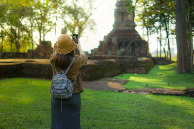 Rear view of woman standing at park