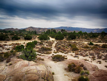 Scenic view of mountains against cloudy sky