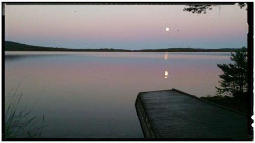 Scenic view of calm lake at sunset