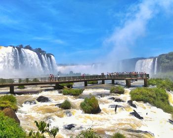 Scenic view of waterfall against sky