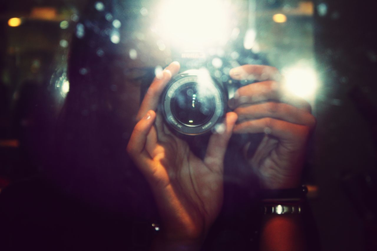 lifestyles, leisure activity, person, holding, lens flare, sun, photography themes, men, part of, photographing, close-up, sunbeam, sunlight, focus on foreground, car, reflection, camera - photographic equipment