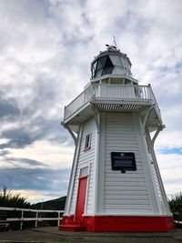 Low angle view of lighthouse against cloudy sky