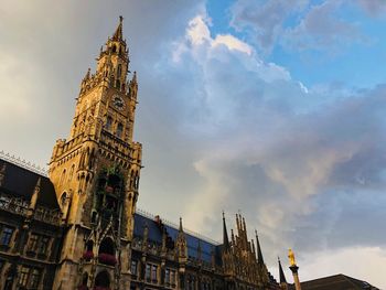 Low angle view of buildings against cloudy sky