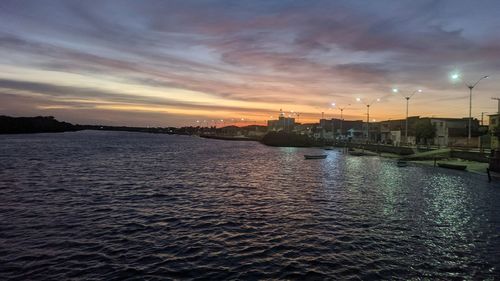 Scenic view of river against sky at sunset