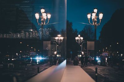 Illuminated street lights at dusk
