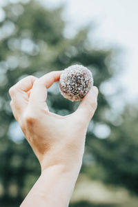 Close-up of hand holding ice cream