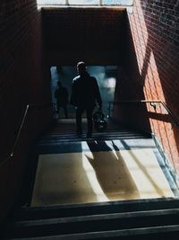 Silhouette people walking on staircase