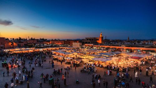 Crowd in city at sunset