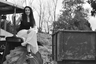 Portrait of smiling young woman sitting outdoors