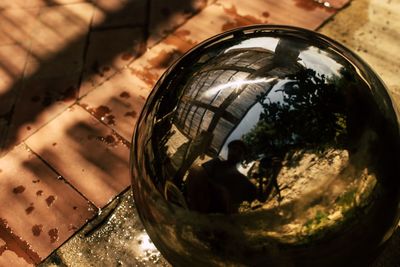 High angle view of glass with reflection on table