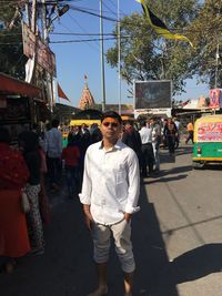 People standing on street market in city