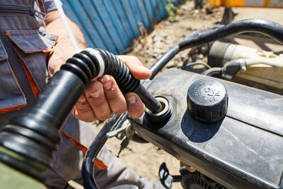 Midsection of man repairing car