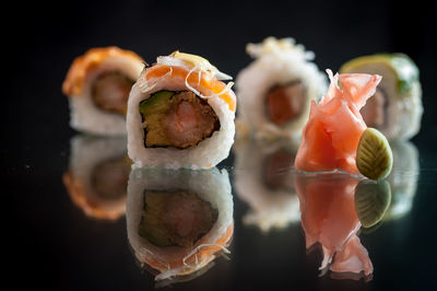 Close-up of sushi against black background