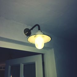 Low angle view of illuminated lamp hanging on ceiling