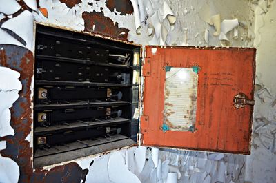 Old machinery in rusty storage on peeling wall