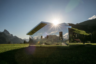 Mirage gstaad scenic view of field against sky on sunny day