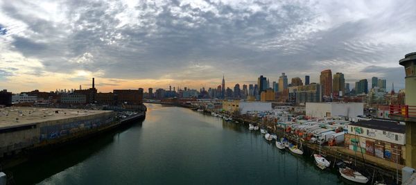 Buildings against cloudy sky seen from pulaski bridge