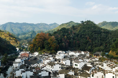 High angle view of townscape and mountains against sky