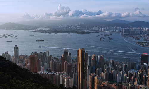 High angle view of city by sea against sky