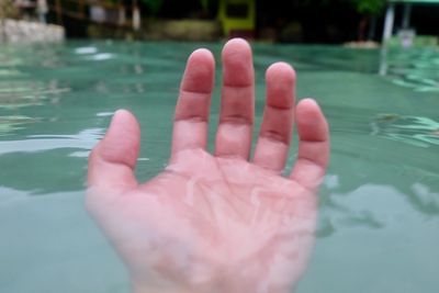 Close-up of hand with water