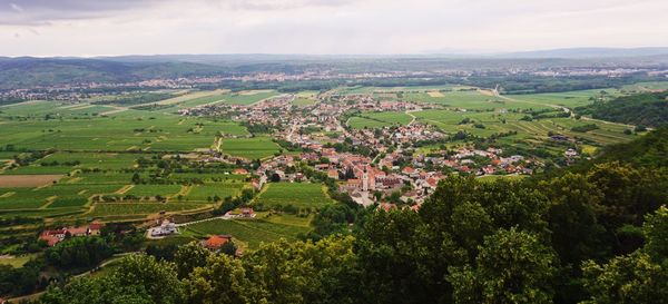 Aerial view of green landscape against sky