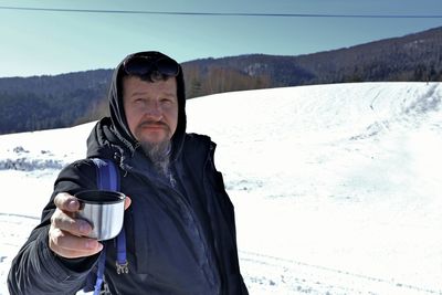 Portrait of mature man drinking water