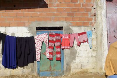 Clothes drying against brick wall