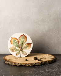 Botanical bas-relief chestnut leaf on wooden stand. stylish and modern interior of room.