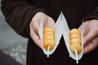 Midsection of person holding ice cream