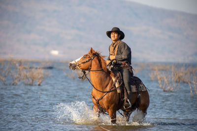 Man riding horse in sea