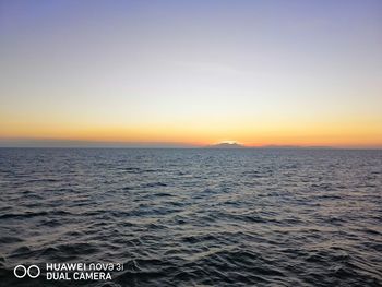 Scenic view of sea against clear sky during sunset