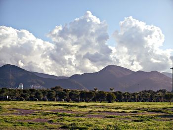 Scenic view of mountains against cloudy sky