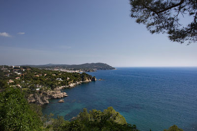 High angle view of townscape by sea against sky