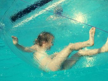 Girl in water ball on swimming pool