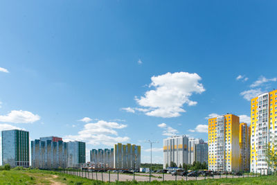 Buildings in city against blue sky