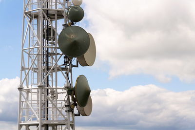 Low angle view of communications tower against sky