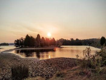 Scenic view of lake against sky during sunset