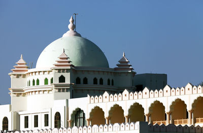 Exterior of temple against clear blue sky