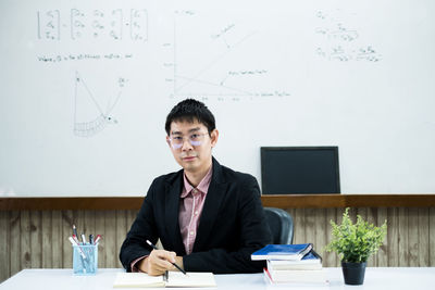 Portrait of businessman sitting at office